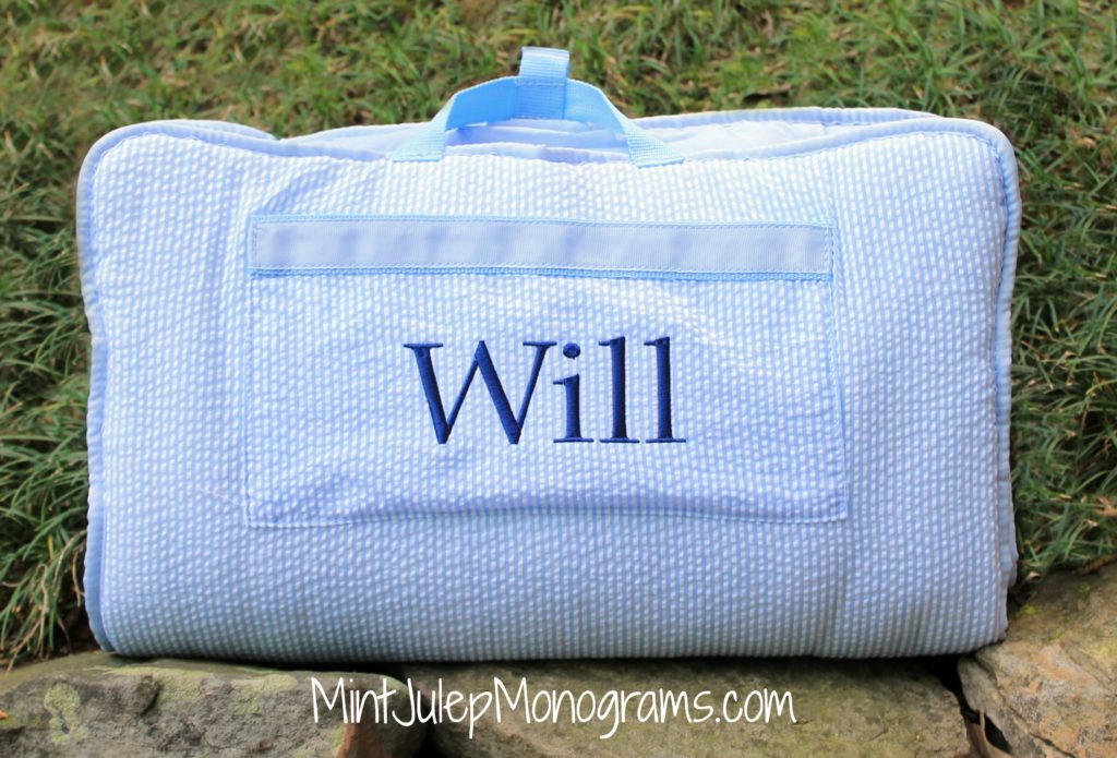 baby blue seersucker nap mat embroidered with Will in navy thread in the library font