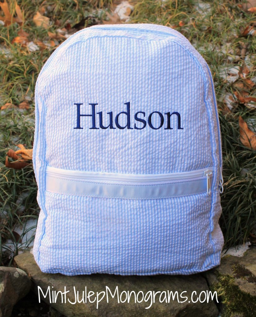 Baby blue seersucker large backpack embroidered with name Hudson in navy thread in the Library font