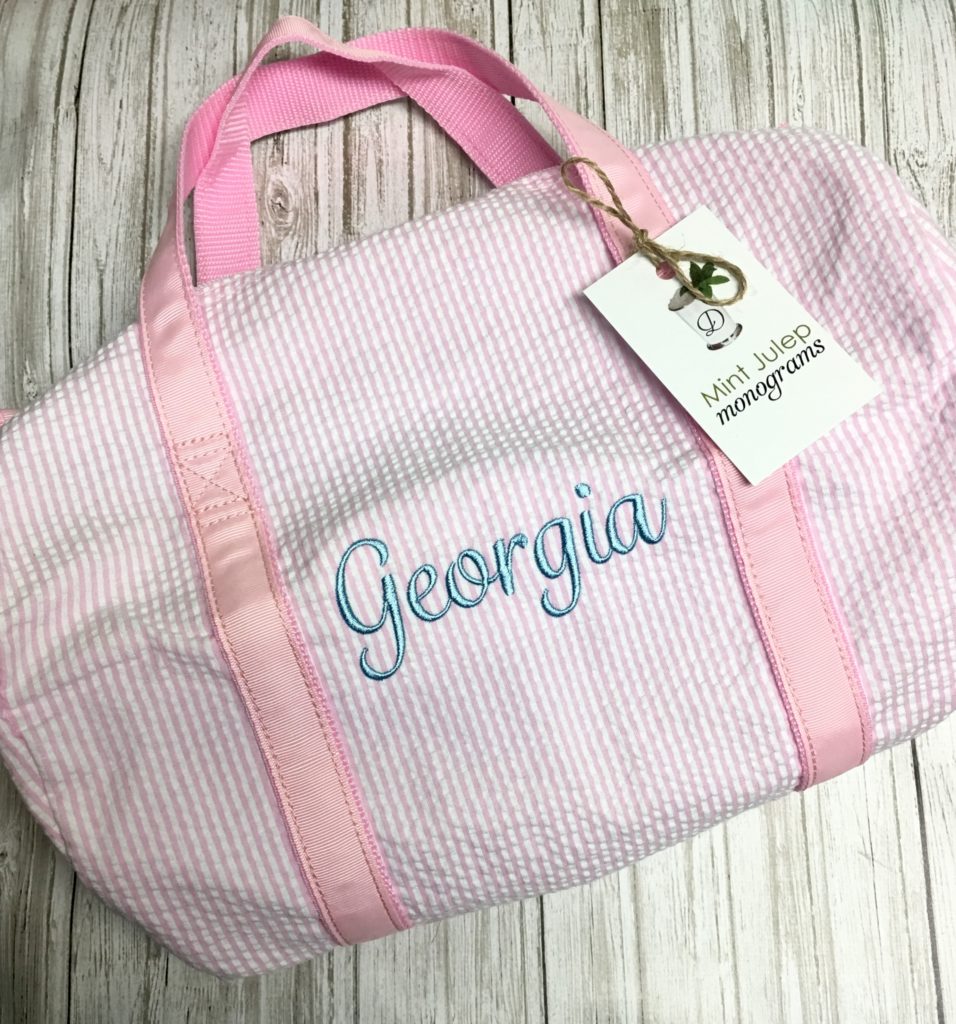 pink seersucker small duffel bag, baby blue thread, Juniper font