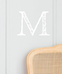 white wall sign with initial